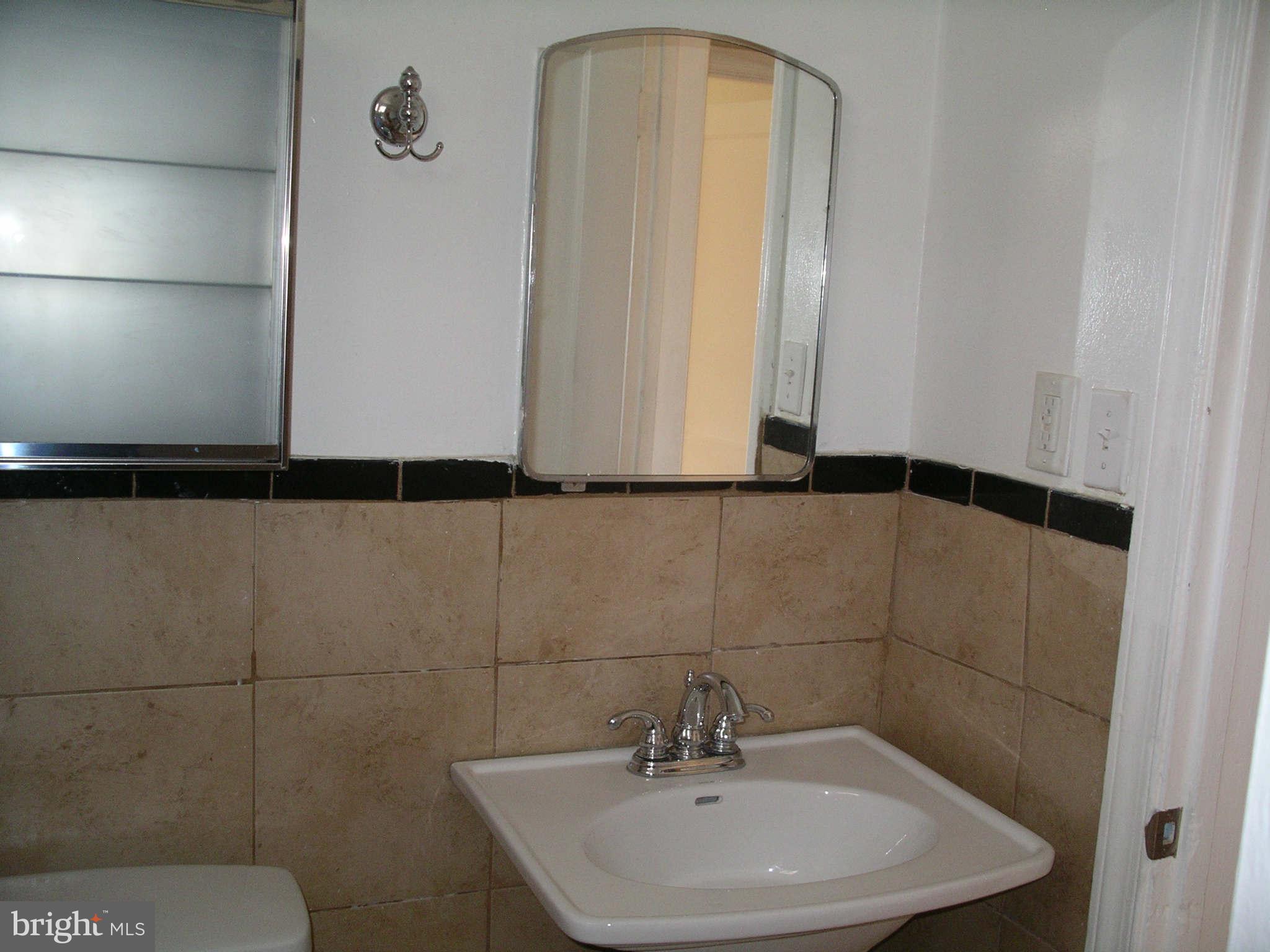 1226 Simms Place Northeast Washington, DC 20002 - Photo 12 of 15 a bathroom with a sink and mirror