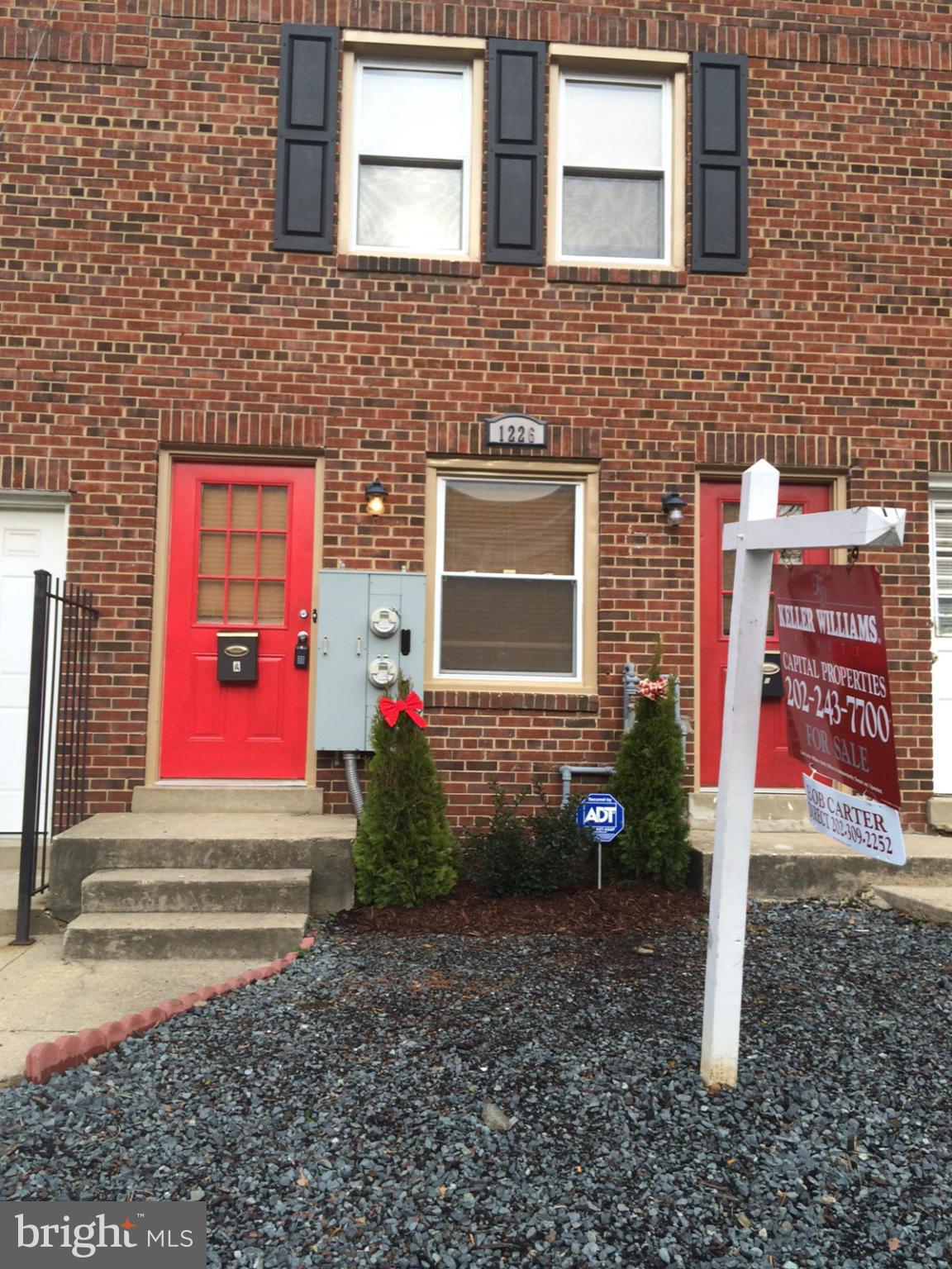 1226 Simms Place Northeast Washington, DC 20002 - Photo 2 of 15 a front view of a house with lots of trees