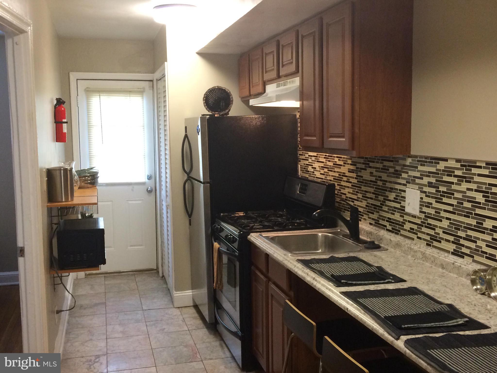 1226 Simms Place Northeast Washington, DC 20002 - Photo 6 of 15 a kitchen with a stove and a refrigerator