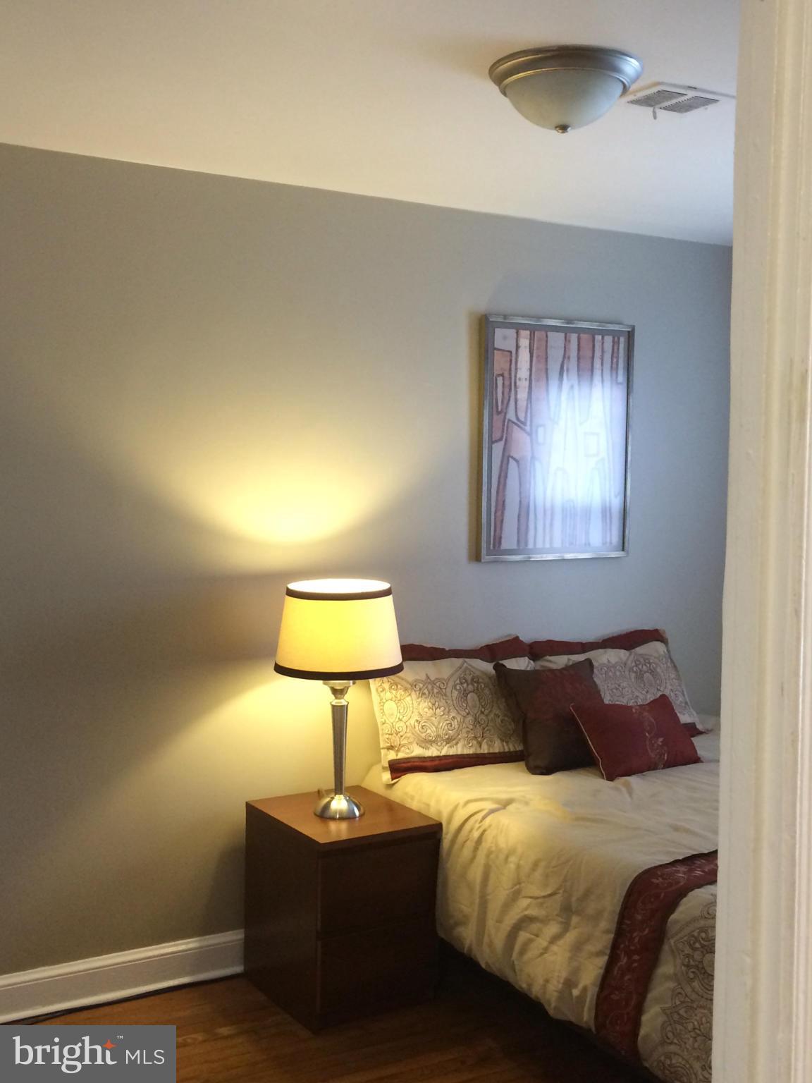 1226 Simms Place Northeast Washington, DC 20002 - Photo 10 of 15 a bedroom with a bed and a lamp