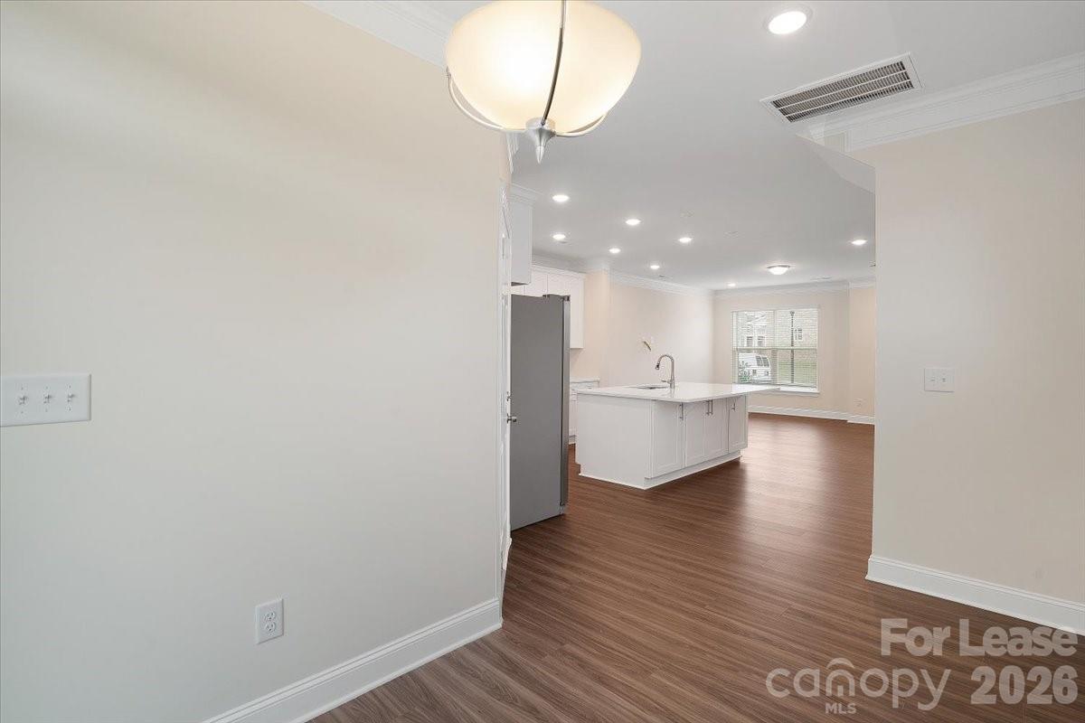 5569 Stafford Road Charlotte, NC 28215 - Photo 13 of 29 an empty room with wooden floor and windows