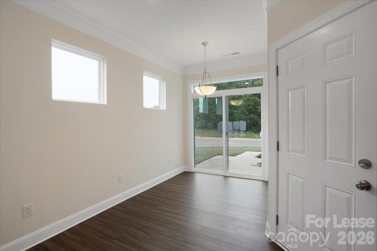 5569 Stafford Road Charlotte, NC 28215 - Photo 14 of 29 an empty room with wooden floor and windows