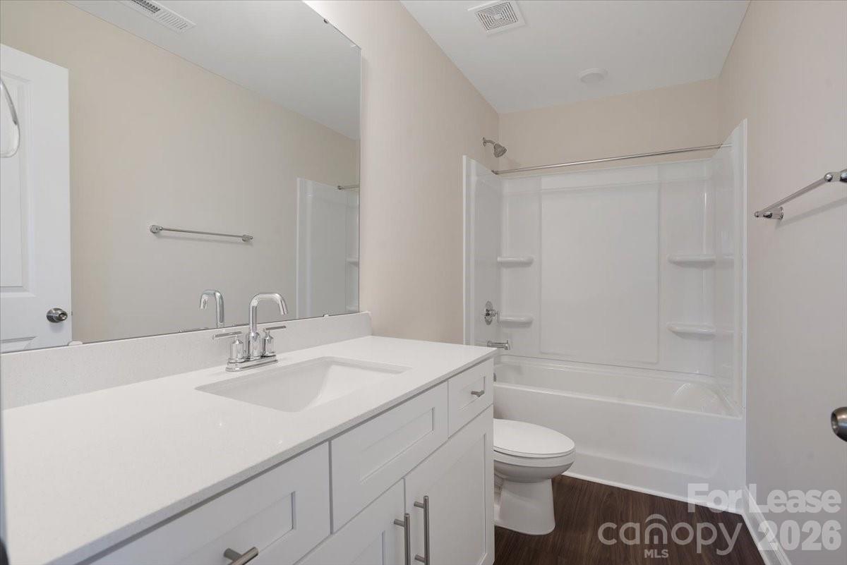 5569 Stafford Road Charlotte, NC 28215 - Photo 18 of 29 a bathroom with a sink a toilet and shower
