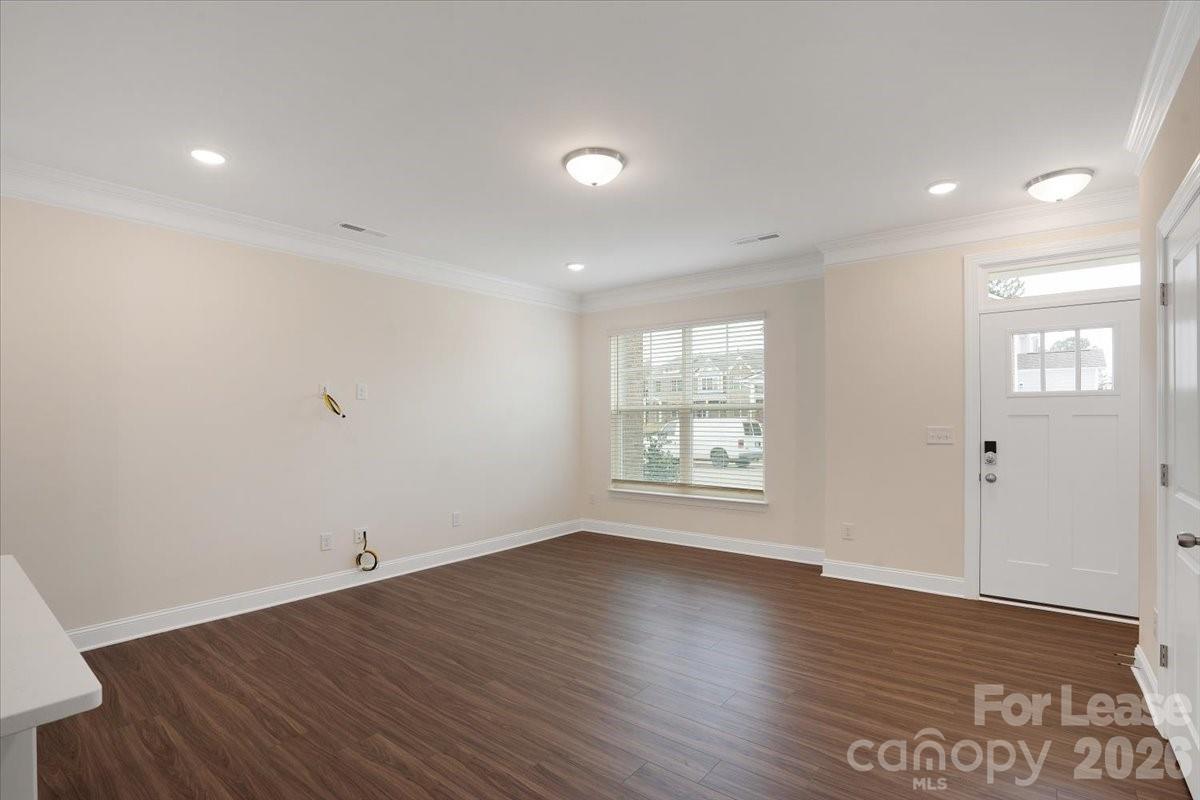 5569 Stafford Road Charlotte, NC 28215 - Photo 3 of 29 an empty room with wooden floor and window