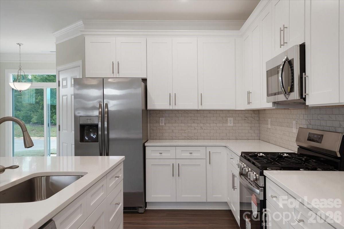 5569 Stafford Road Charlotte, NC 28215 - Photo 10 of 29 a kitchen with stainless steel appliances granite countertop a sink stove and refrigerator