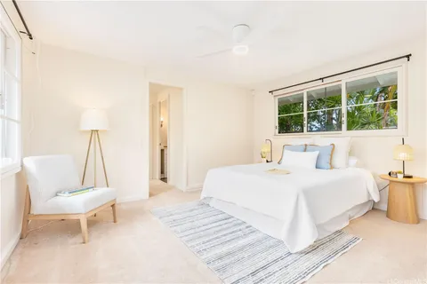 a bedroom with a bed and a chair