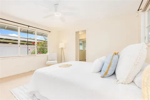 a bedroom with a bed and a large window
