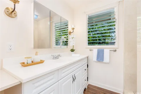 a bathroom with a sink and a window