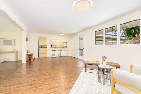 a living room with furniture and floor to ceiling windows