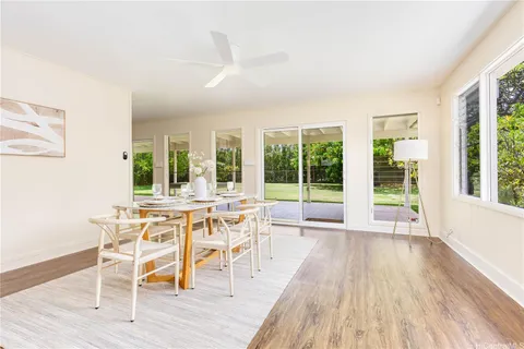 a view of a dining room with furniture wooden floor and chandelier