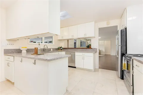a kitchen with a sink stove and refrigerator