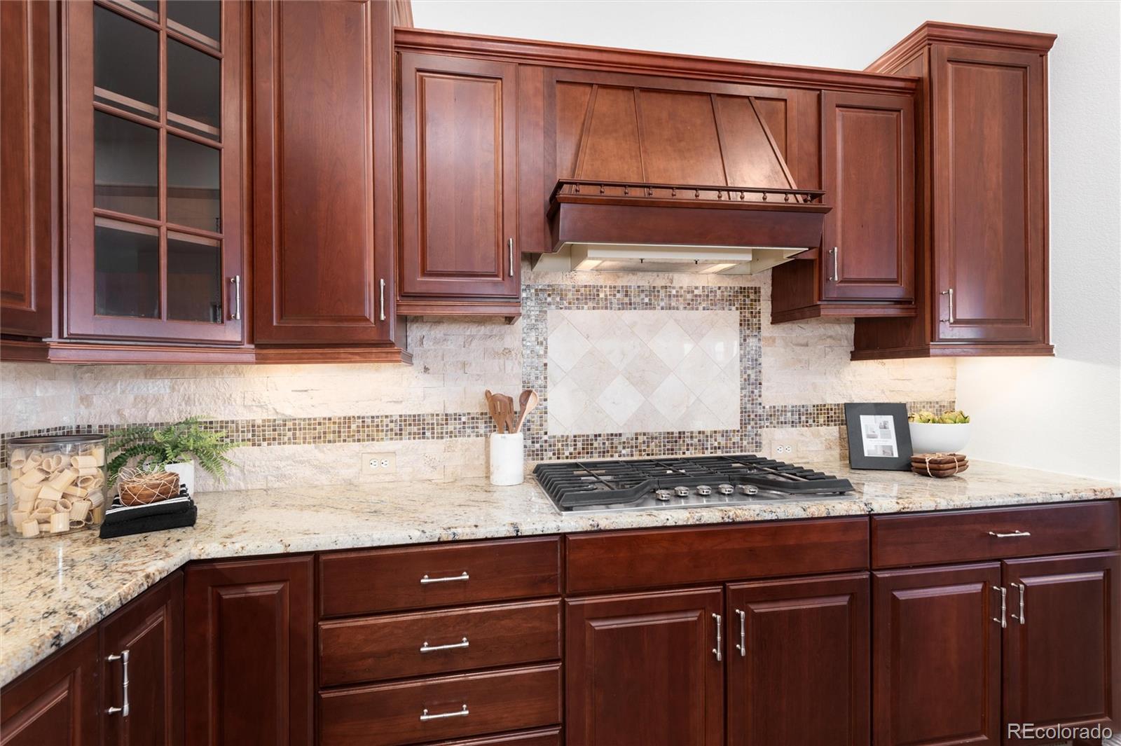10698 Mountaingate Court Highlands Ranch, CO 80126 - Photo 15 of 47 a kitchen with granite countertop cabinets and stove