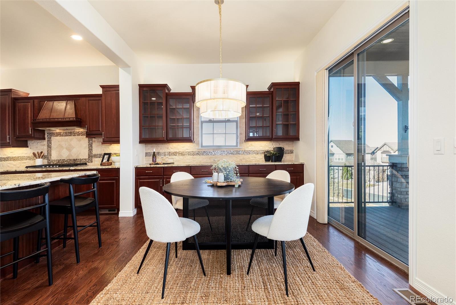 10698 Mountaingate Court Highlands Ranch, CO 80126 - Photo 20 of 47 a view of a dining room with furniture window and wooden floor