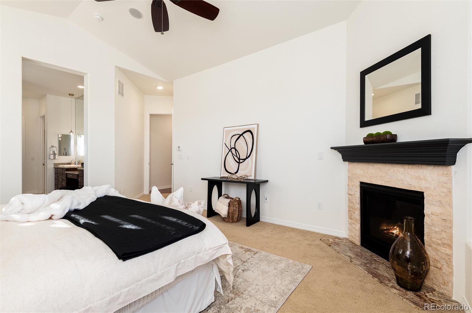 10698 Mountaingate Court Highlands Ranch, CO 80126 - Photo 22 of 47 a bedroom with a bed and a fireplace