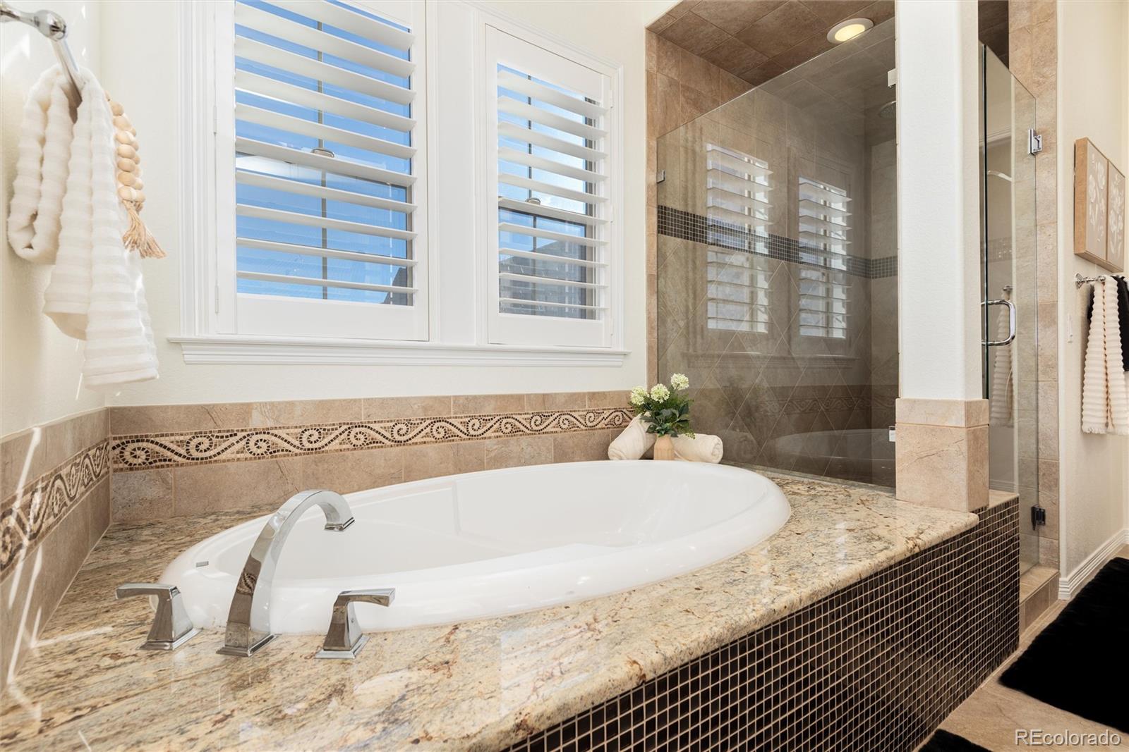 10698 Mountaingate Court Highlands Ranch, CO 80126 - Photo 23 of 47 a bathroom with bathtub and shower