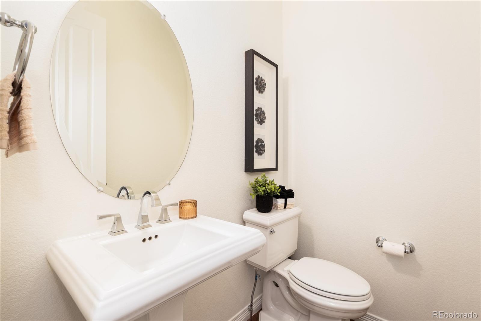 10698 Mountaingate Court Highlands Ranch, CO 80126 - Photo 26 of 47 a bathroom with a sink mirror and toilet
