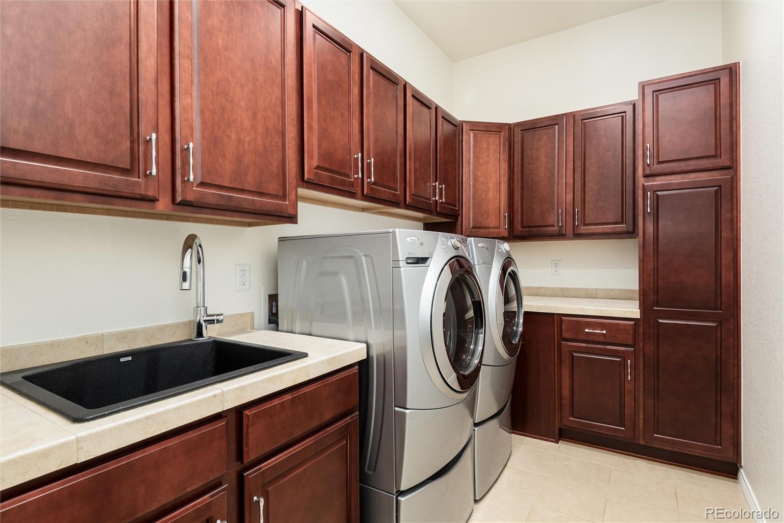 10698 Mountaingate Court Highlands Ranch, CO 80126 - Photo 27 of 47 a kitchen with a sink cabinets and stainless steel appliances
