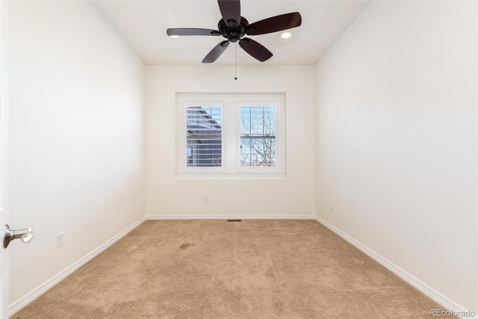 10698 Mountaingate Court Highlands Ranch, CO 80126 - Photo 29 of 47 an empty room with chandelier fan
