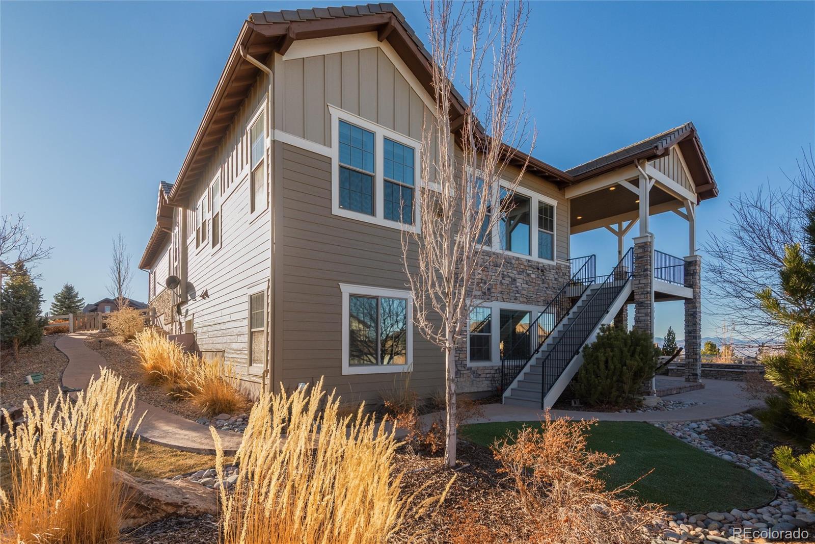10698 Mountaingate Court Highlands Ranch, CO 80126 - Photo 38 of 47 a view of a house with a yard