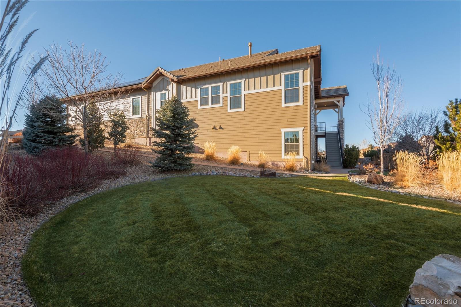 10698 Mountaingate Court Highlands Ranch, CO 80126 - Photo 47 of 47 a front view of a house with a yard