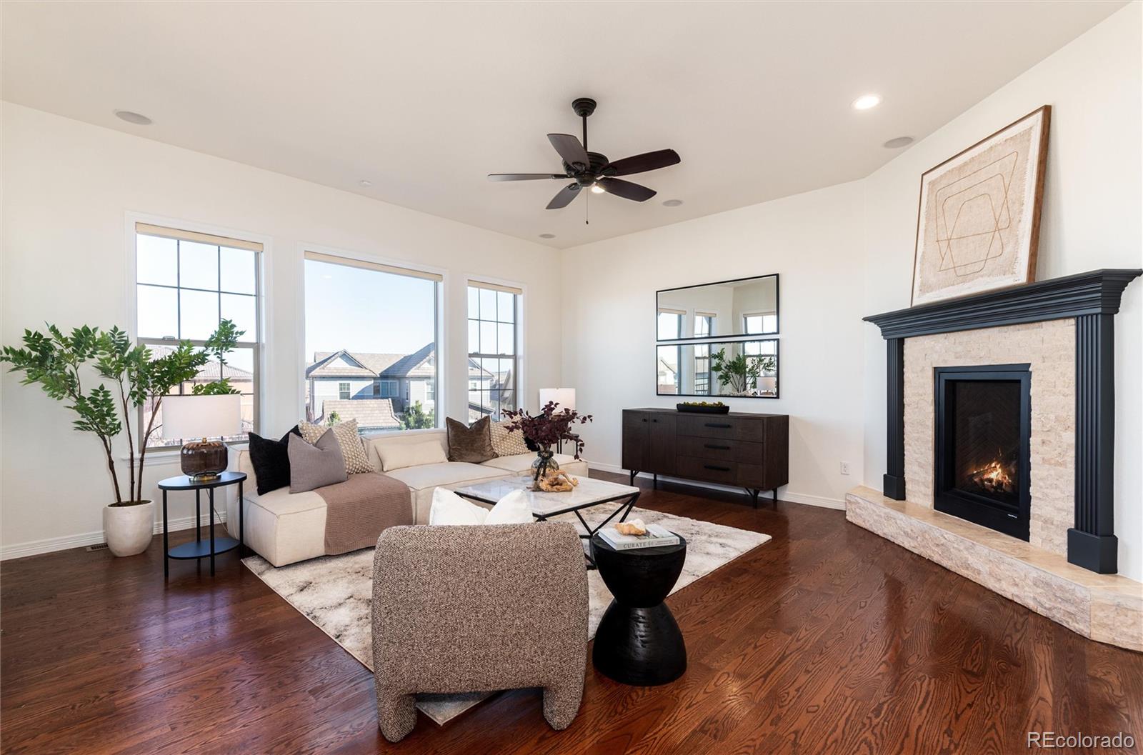 10698 Mountaingate Court Highlands Ranch, CO 80126 - Photo 5 of 47 a living room with furniture or window and a fireplace