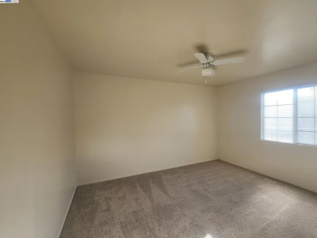 an empty room with windows and closet