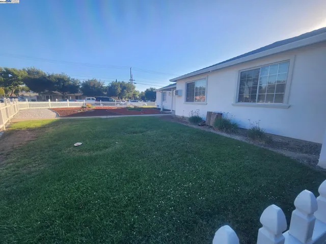a backyard of a house with table and chairs