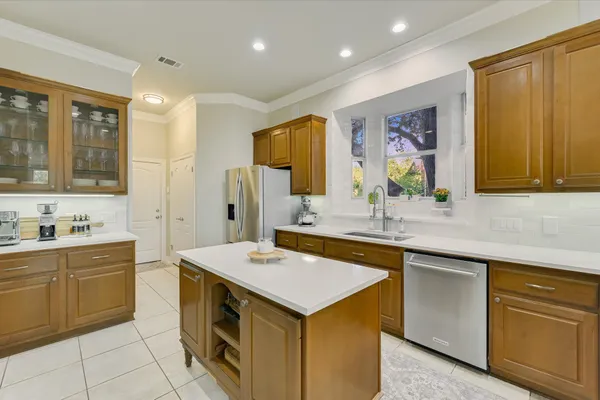 a kitchen with a sink stove and cabinets