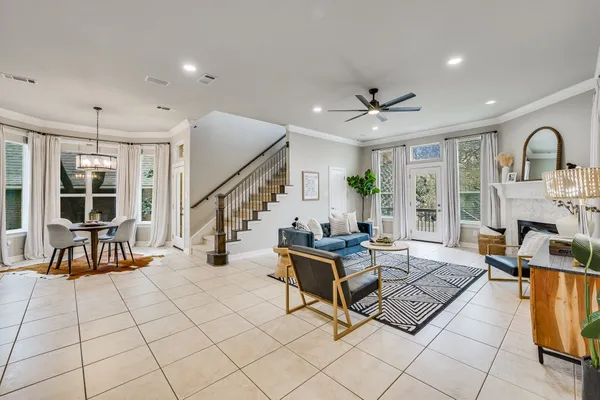 a living room with furniture a fireplace and a flat screen tv