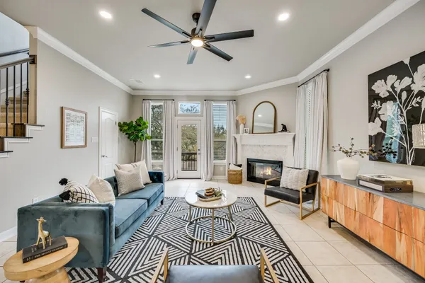 a living room with furniture fireplace and a large window