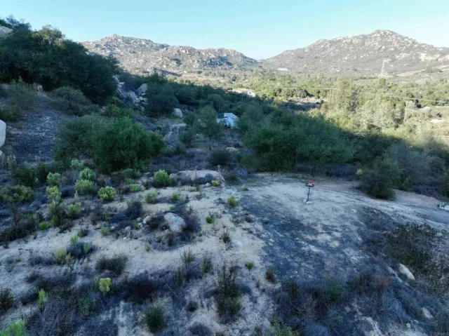 an aerial view of a house with mountain view