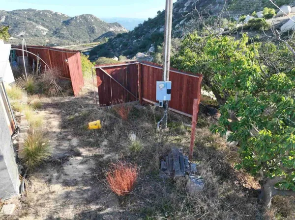 a backyard of a house with table and chairs