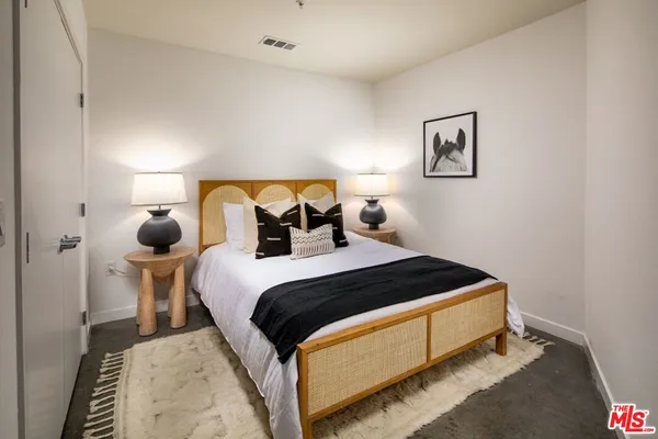 a bedroom with a bed and window