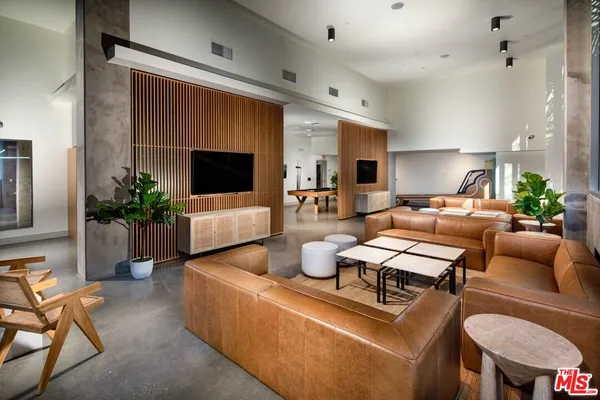 a living room with furniture a flat screen tv and a large window