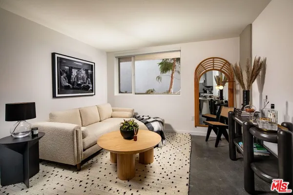 a bedroom with a bed and painting on the wall