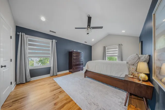 a bedroom with a bed window and dresser