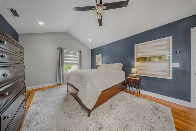 a bedroom with a bed dresser and a window