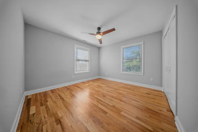 wooden floor in an empty room with a window