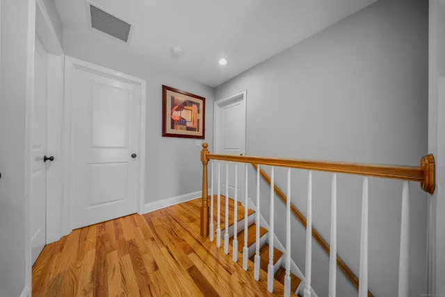 a view of a hallway with wooden floor