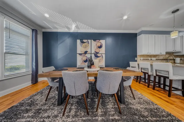 a view of a dining room with furniture window and wooden floor