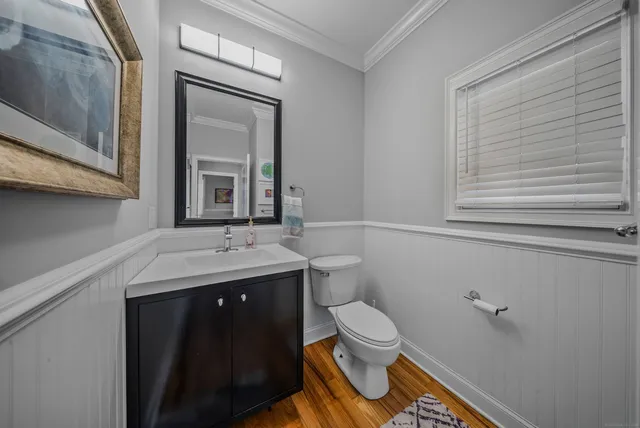 a bathroom with a sink a toilet and mirror
