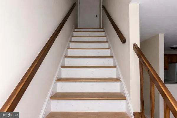a view of a hallway with wooden floor and entryway