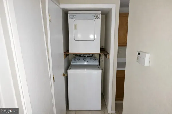 a kitchen with a refrigerator sink and cabinets