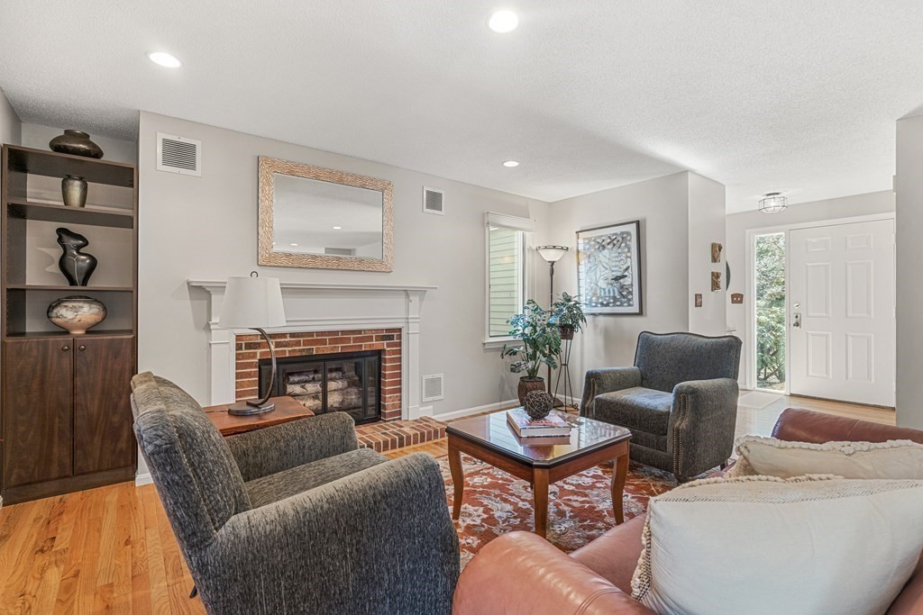 7 Coltsway, Unit 7 Wayland, MA 01778 - Photo 11 of 26 a living room with furniture and a fireplace
