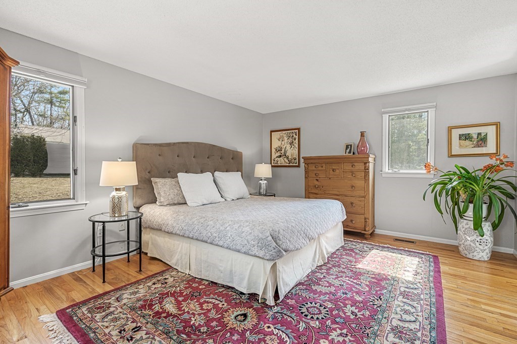 7 Coltsway, Unit 7 Wayland, MA 01778 - Photo 13 of 26 a bedroom with a bed and wooden floor