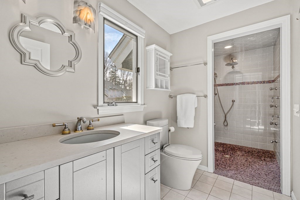 7 Coltsway, Unit 7 Wayland, MA 01778 - Photo 14 of 26 a bathroom with a granite countertop sink a toilet and a mirror