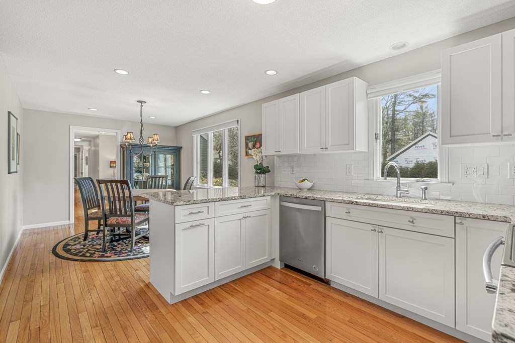 7 Coltsway, Unit 7 Wayland, MA 01778 - Photo 4 of 26 a kitchen with sink cabinets and wooden floor