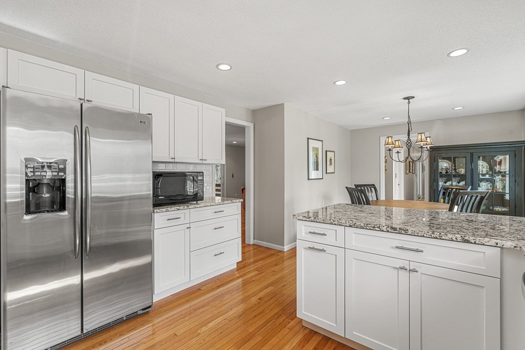 7 Coltsway, Unit 7 Wayland, MA 01778 - Photo 7 of 26 a kitchen with a refrigerator a sink and cabinets