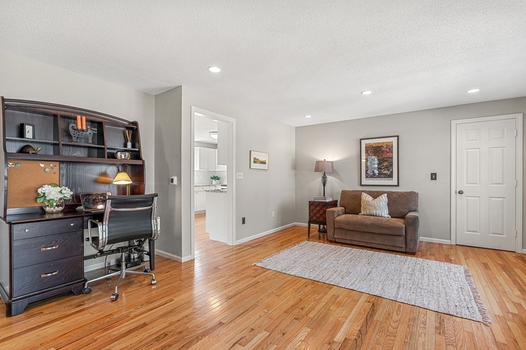 7 Coltsway, Unit 7 Wayland, MA 01778 - Photo 8 of 26 a living room with furniture and a wooden floor