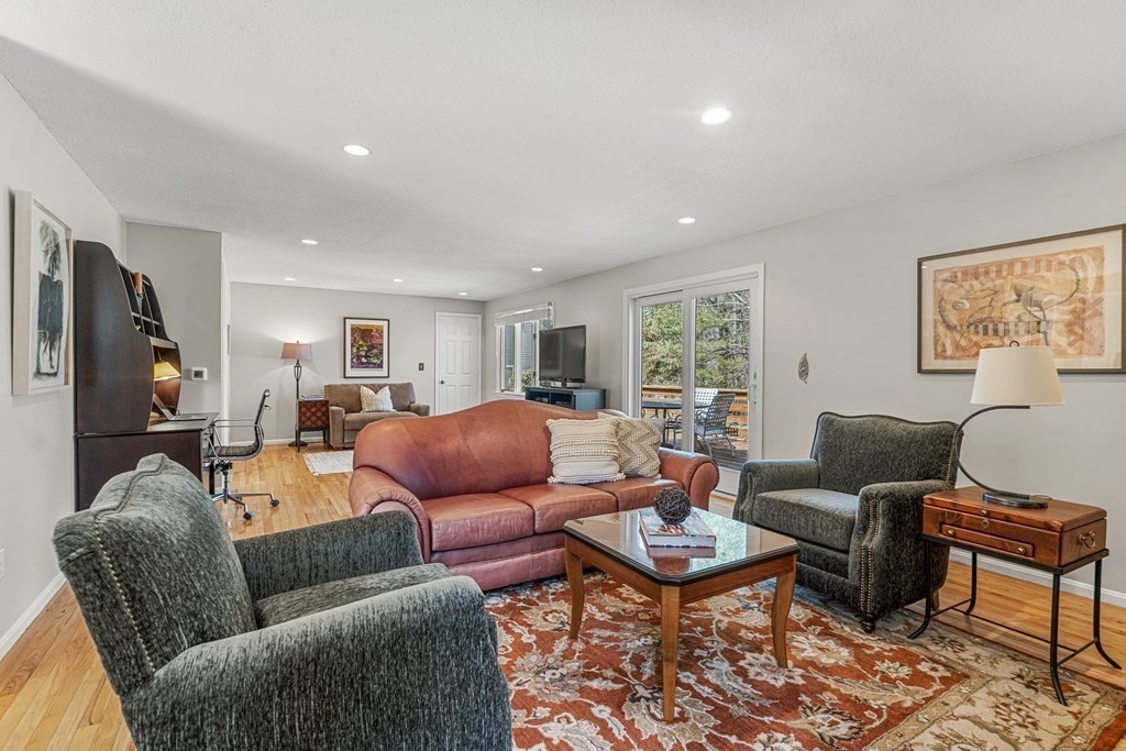 7 Coltsway, Unit 7 Wayland, MA 01778 - Photo 9 of 26 a living room with furniture a rug and a flat screen tv